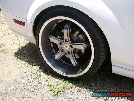 White car rear wheel with custom TSW rims and red side marker