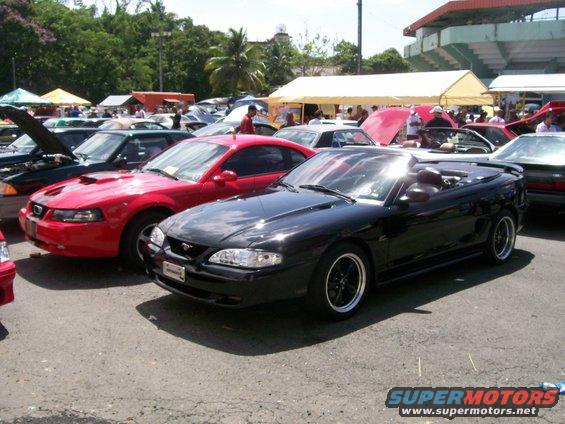 Black convertible Mustang from the mid-1990s parked at a car show