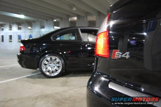 Black Audi S4 rear close-up with a black BMW M3 in the background