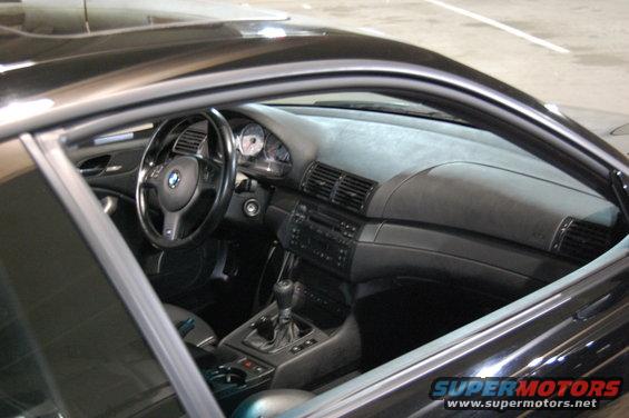 Black 2002 BMW M3 interior with manual transmission and dashboard gauges