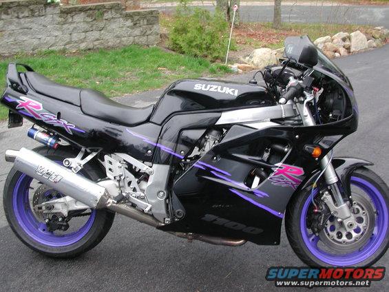 Black Suzuki motorcycle with purple "GSX-R" and "1100" graphics, side view