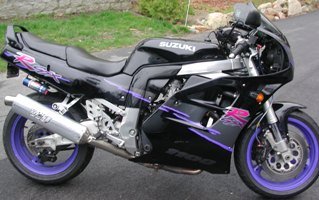 Black Suzuki GSX-R 1100 motorcycle with purple accents and wheels. Exhaust is Yoshimura