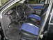2003 Ford Focus - The interior of a 2003 Ford Focus shows its distinctive blue and black seats and dashboard layout.