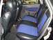 2003 Ford Focus - Rear interior view of a 2003 Ford Focus, highlighting the blue and black patterned seats.