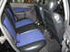 2003 Ford Focus - The interior of the vehicle features black leather seats with blue fabric inserts and black door panels.