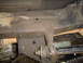 1979 Ford Bronco - Close-up view of the rusty undercarriage and suspension system of a vehicle.