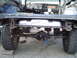 1979 Ford Bronco - The rear axle and fuel tank of a 1979 Ford Bronco are visible, showing modifications for off-road use.