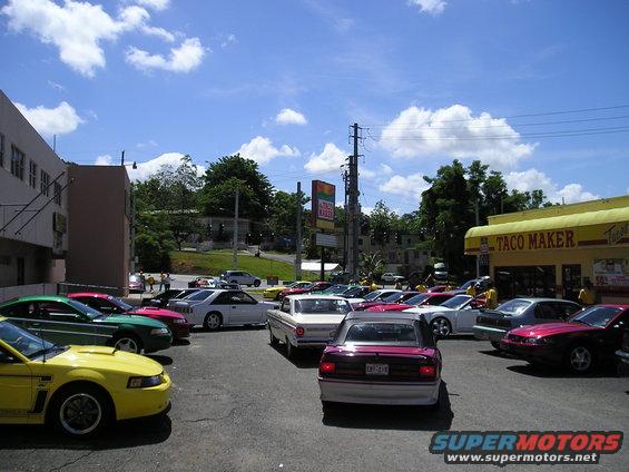 Yellow 2001 Ford Mustang front view in a parking lot with other cars