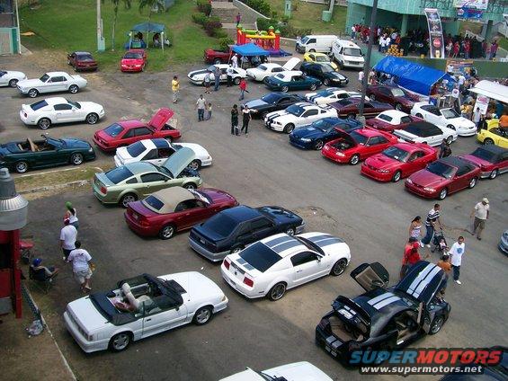 White 2005 Ford Mustang coupe with racing stripes parked