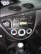 2003 Ford Focus - The interior of a 2003 Ford Focus, showing the center console with the radio and climate controls.