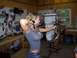 1979 Ford Bronco - A woman practices archery indoors with a compound bow.