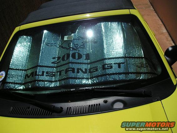 Yellow 2001 Ford Mustang GT windshield with sunshade showing text