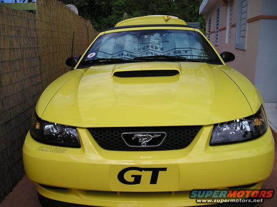 Yellow 2001 Ford Mustang GT front view with GT badge and pony emblem