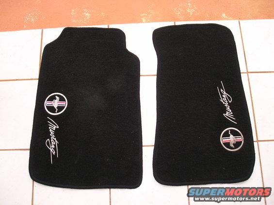 Two black Ford Mustang floor mats with embroidered logos and script
