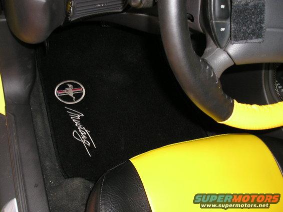 Black floor mat with silver Mustang logo and script