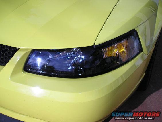 yellow 2001 Ford Mustang front corner with headlight and grille detail