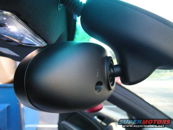 Close-up of a car's interior rearview mirror assembly, showing the housing and mounting
