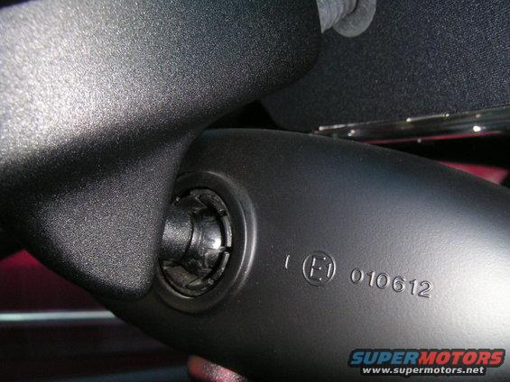 Black interior rear view mirror assembly with E1 010612 marking and Supermotors.net watermark