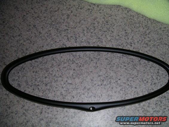 Black gauge cluster bezel with a single mounting hole