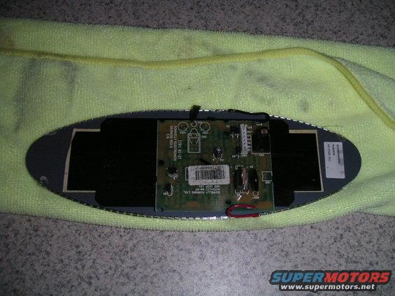 circuit board with wires and components, resting on a yellow cloth