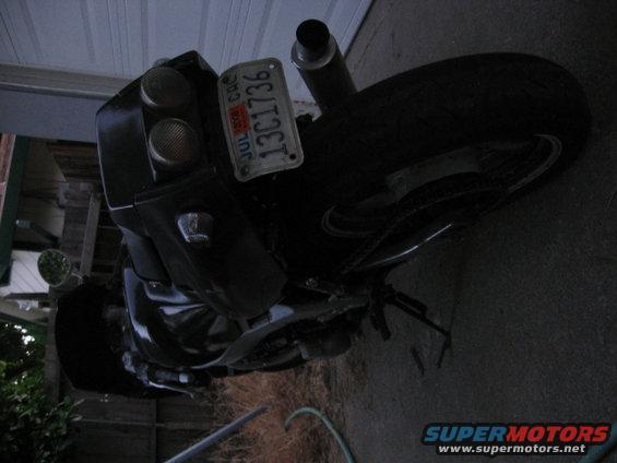 Black motorcycle rear with dual taillights and a California license plate reading 13C1736