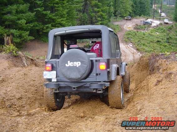 1995 Jeep Wrangler rear view on muddy trail