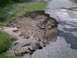2001 Dodge 2500 - Road damage from flooding shows significant erosion and broken pavement.
