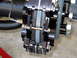 1996 Ford Bronco - Close-up view of a vehicle's brake caliper and pads, showing mechanical components.