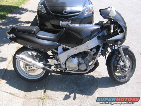 Black 1990 Yamaha FZR600 motorcycle parked on pavement, side view