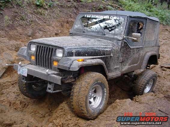 1995 Jeep Wrangler stuck in mud, front bumper has a license plate