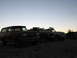 1996 Ford Bronco - Three SUVs, including a 1996 Ford Bronco, are parked on a hill as the sun sets.