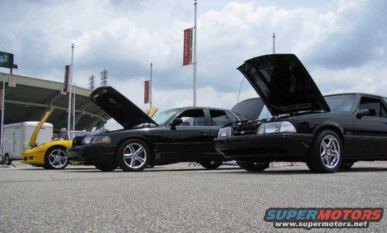 2003 Mercury Marauder and two other cars with hoods up at a car show