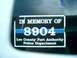 2008 Ford Escape - A memorial decal is affixed to the window of a white vehicle.