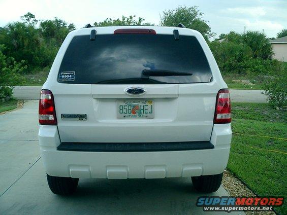 White SUV rear view with a sticker showing '2004'