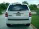 2008 Ford Escape - Rear view of a white SUV, a sticker indicating the year 2004.