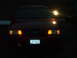 2000 Ford Crown Victoria - Front view of a red 2000 Ford Crown Victoria at night, with its headlights and turn signals illuminated.