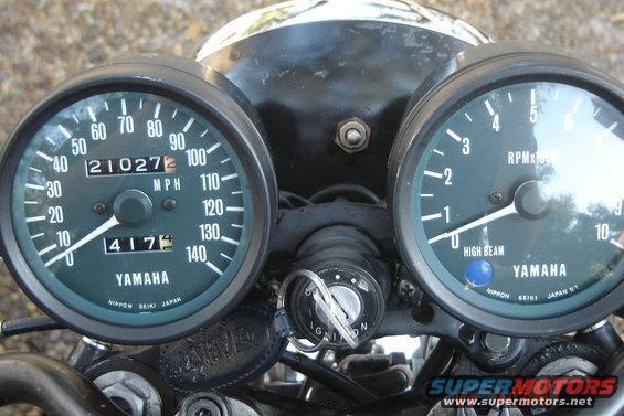 Motorcycle dashboard with two green gauges, one speedometer and one tachometer, both labeled YAMAHA. The speedometer shows 4175 miles