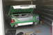 1991 Ford Crown Victoria - A green 1991 Ford Crown Victoria is parked in a storage unit with its trunk open, revealing its interior.