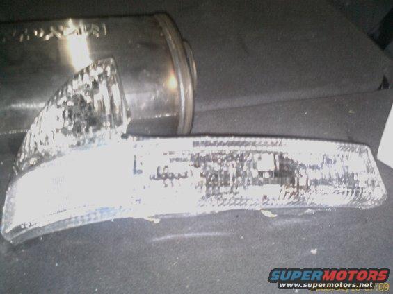 Broken headlight assembly and exhaust pipe