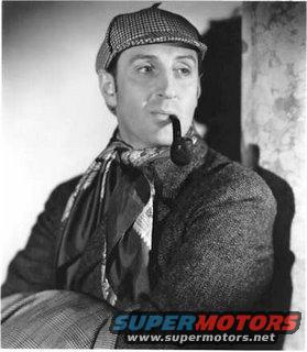 Man in deerstalker hat and scarf smoking a pipe, wearing a tweed coat