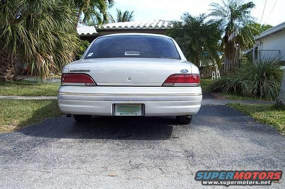 Silver 1992 Ford Crown Victoria sedan, rear view, parked in driveway
