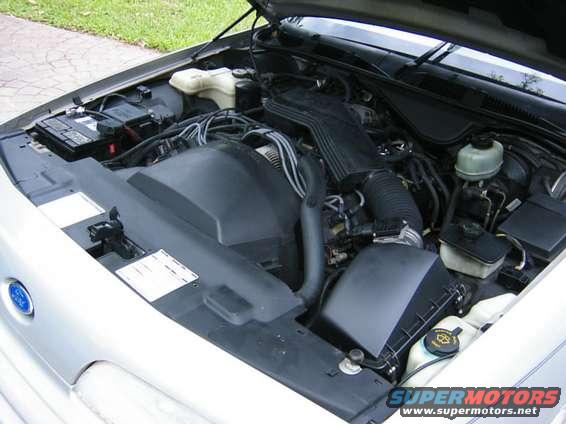 Engine bay of a silver car with hood open