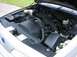 1992 Ford Crown Victoria - The engine bay of a silver car is visible with the hood open, showing various components and wiring.