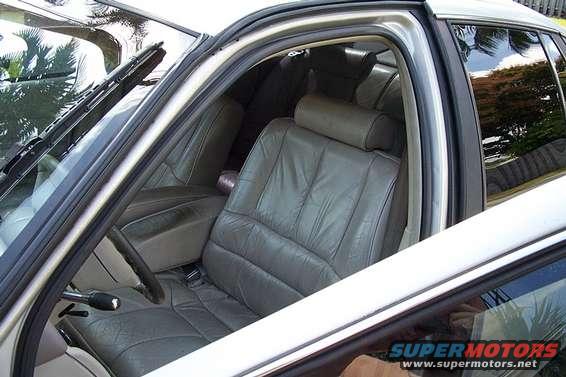 Gray leather seats and interior of a car, viewed from the passenger side