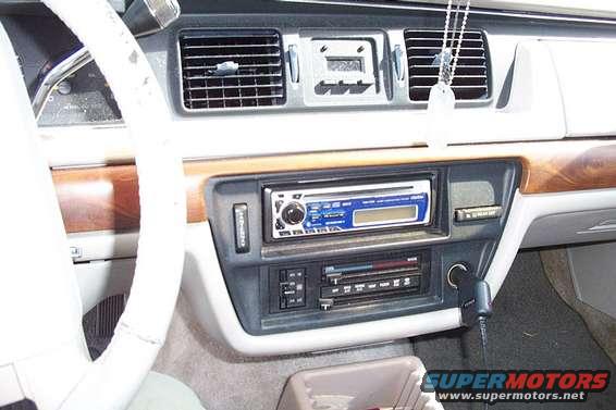 1992 Ford Crown Victoria interior dashboard with wood trim, aftermarket stereo, and air vents