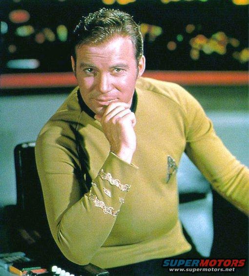 Captain Kirk in his Starfleet uniform, hand on chin, looking thoughtful