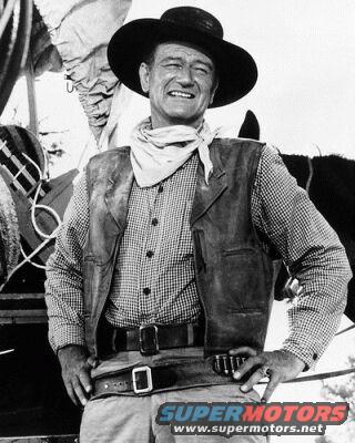 Man in cowboy hat, vest, and bandana, with a watermark reading SUPERMOTORS.NET