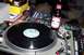 1992 Ford Crown Victoria - A DJ setup with a turntable, mixer, and a bottle of beer is visible in the image.