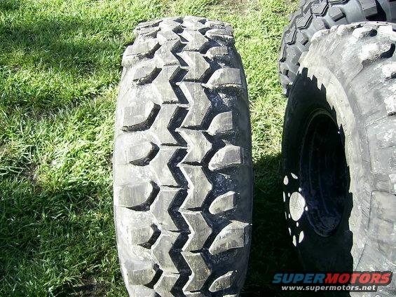Close-up of off-road tire tread with another tire visible
