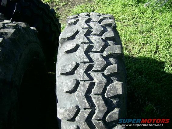 Tire tread with aggressive block pattern, close-up view